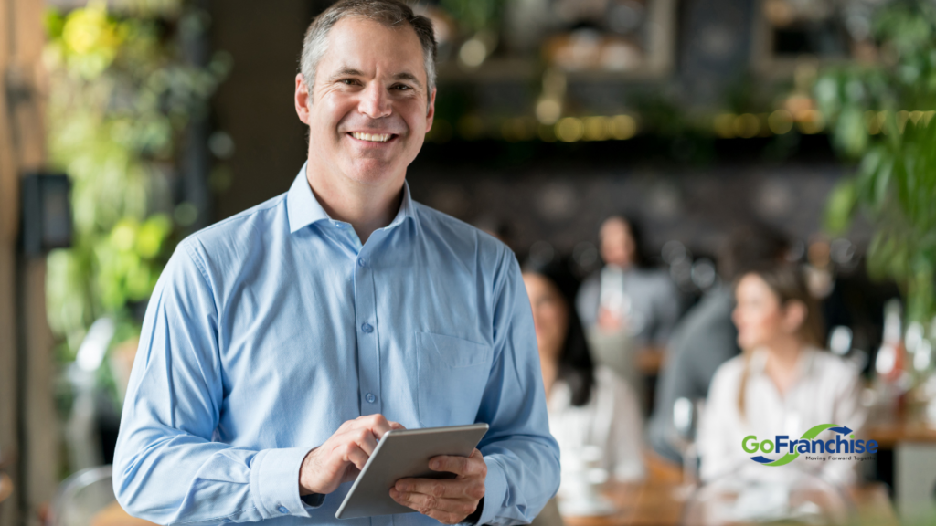 Business Owner holding a tablet his business