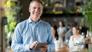 Business Owner holding a tablet his business